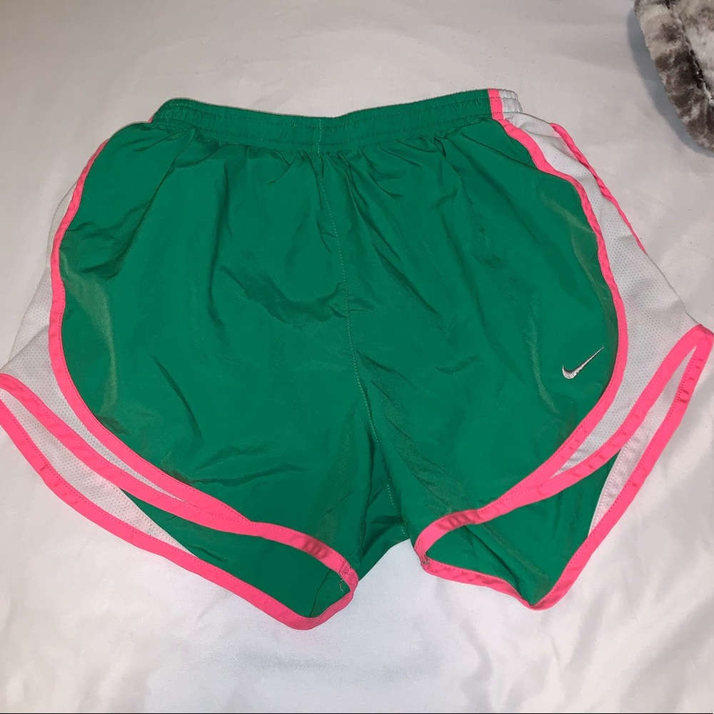 Green Nike shorts with neon pink and white stripe